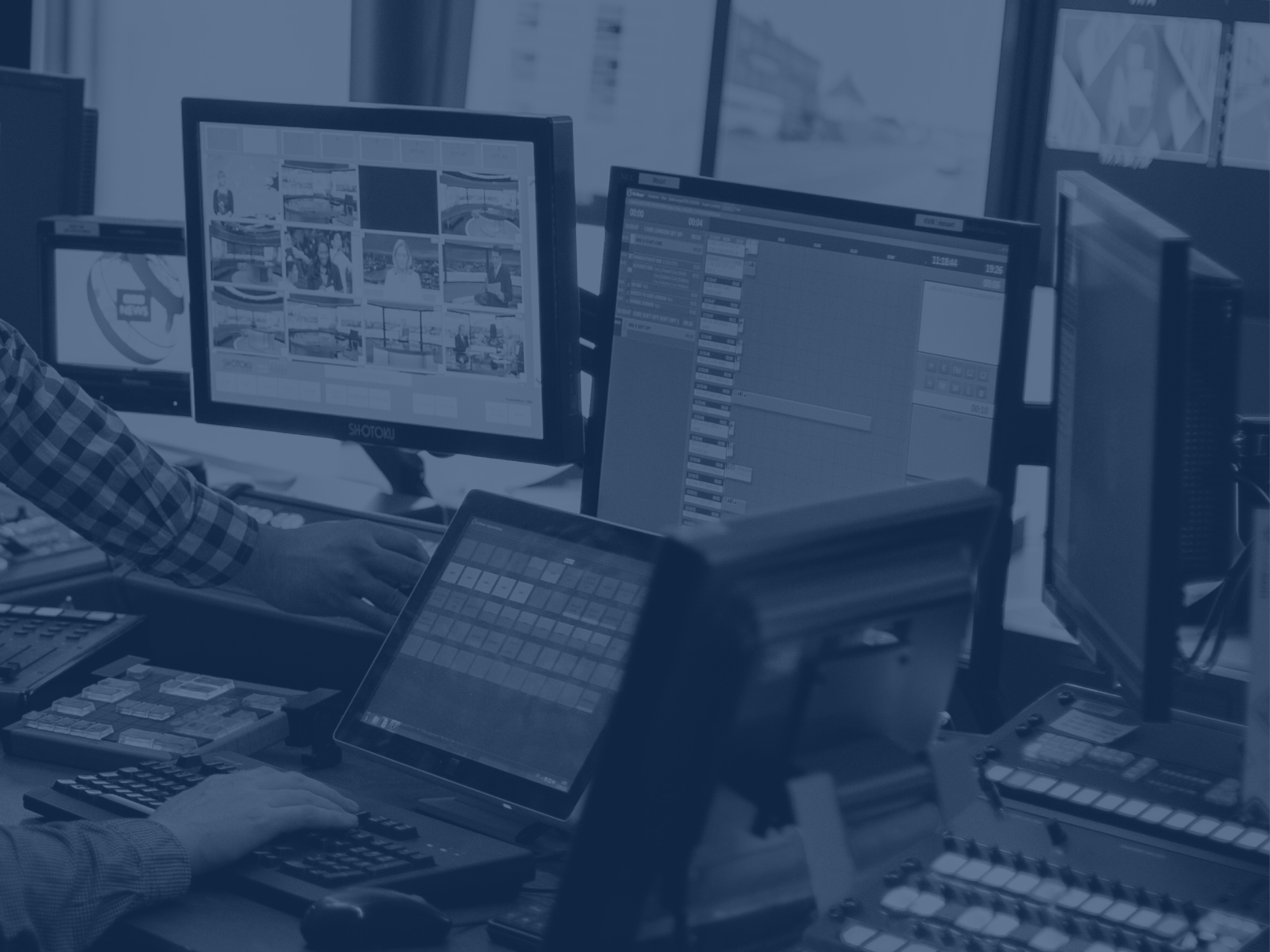 A work station with three different computer monitors, a soundboard and a laptop.